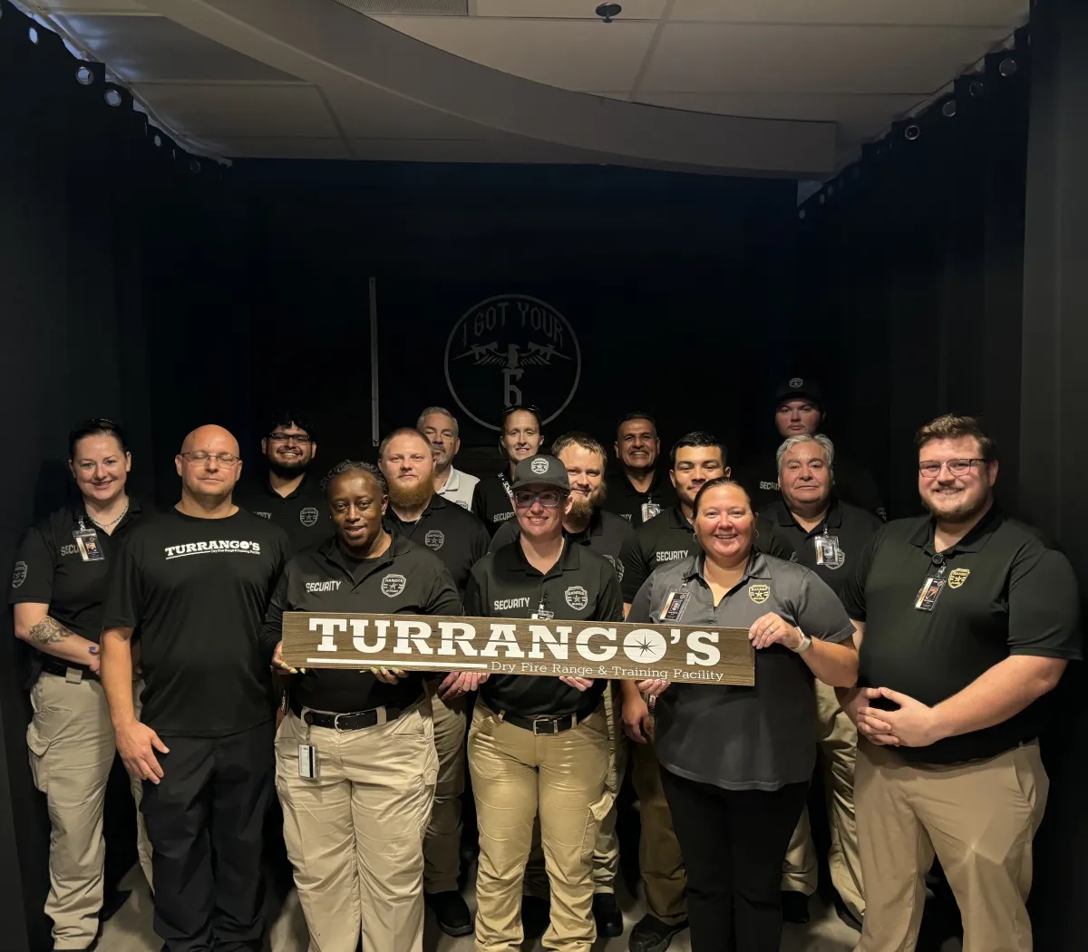 Security Company posing with Turrangos sign