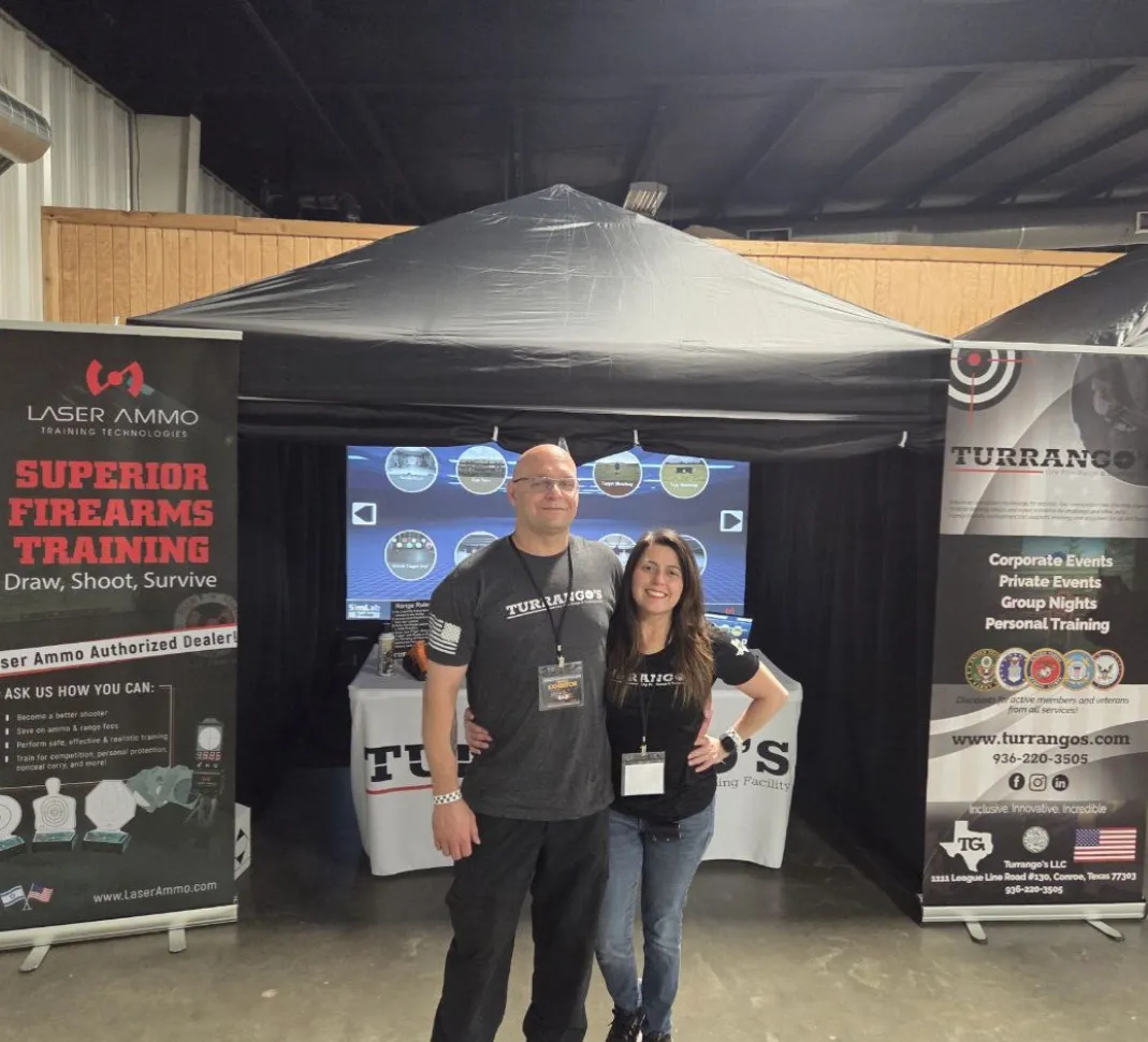 Joe & Cyndi Turrigiano posing in front of a mobile event setup