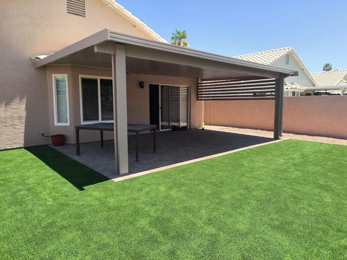 a white car parked on top of a cement wall