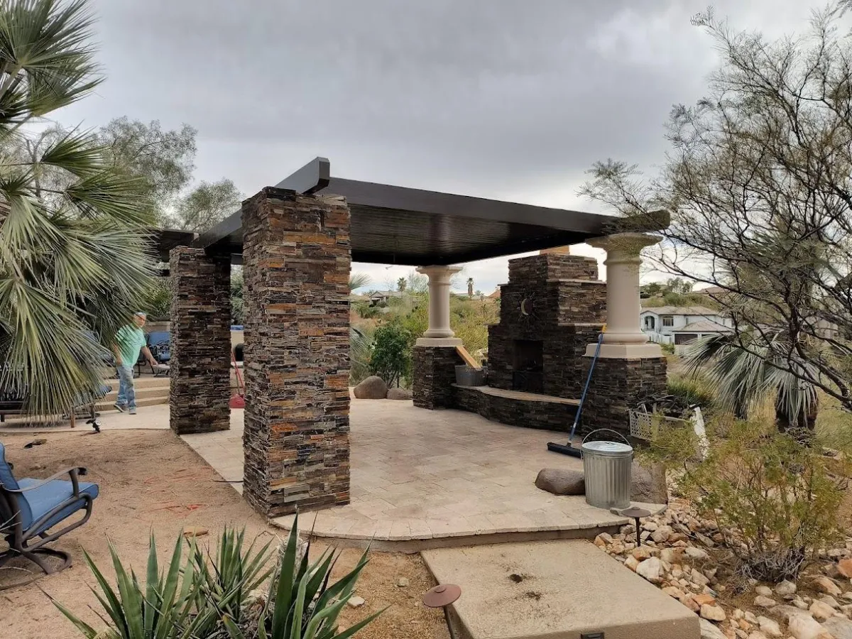 man in red sweater stands on top of hill