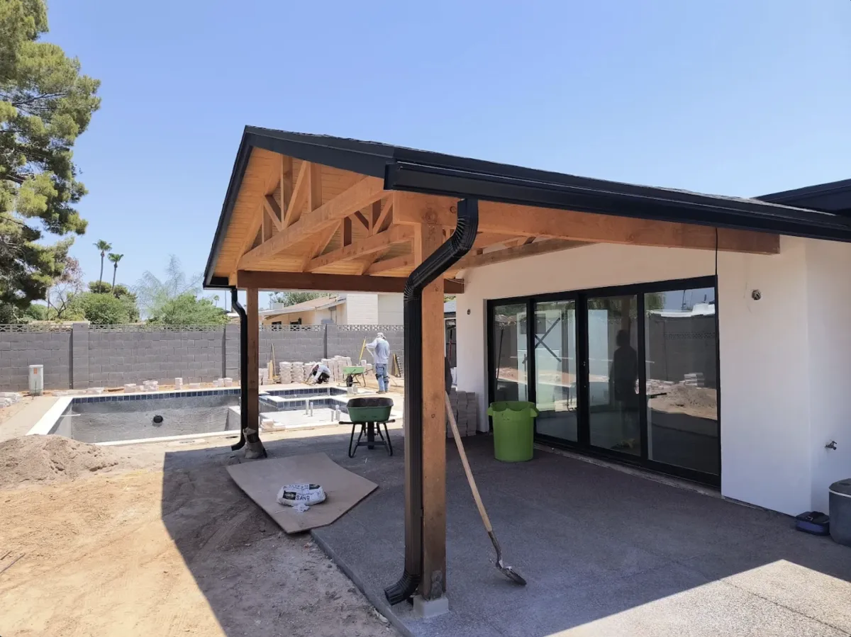 woman in white tank top and black pants sitting on rock mountain during daytime