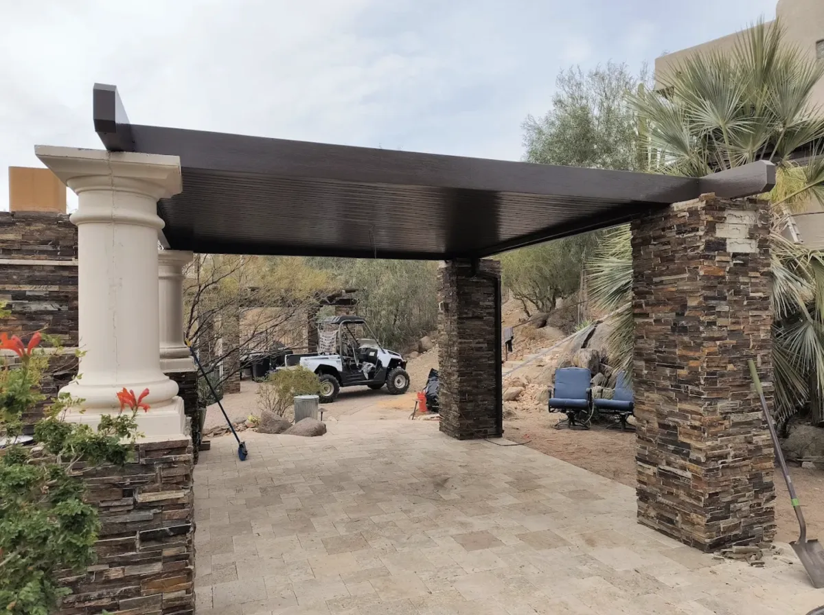 man in red sweater stands on top of hill