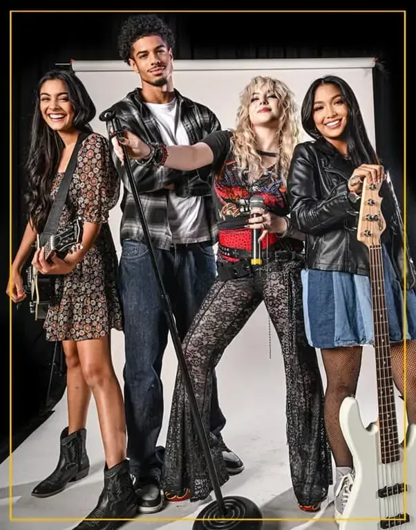 Group of teens playing guitar, bass, and singing during a Rockstars of Tomorrow band lesson program.