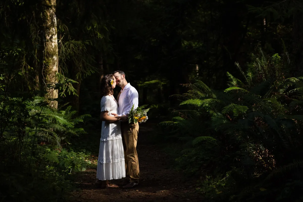 Newlywed couple in the forest at French Beach campground after their wedding