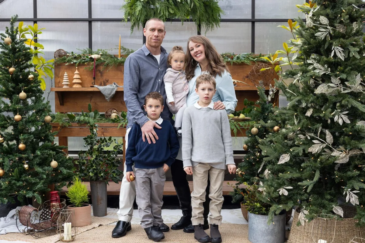 Family Christmas photo inside a styled greenhouse