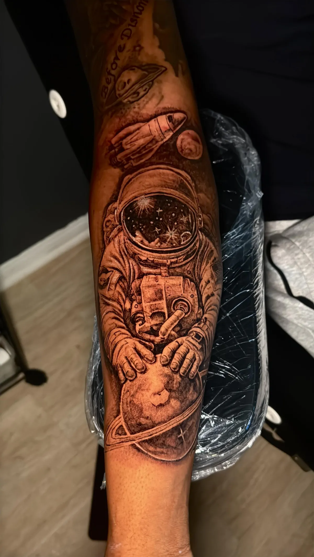 Astronaut tattoo Detailed black and grey astronaut and outer space forearm tattoo