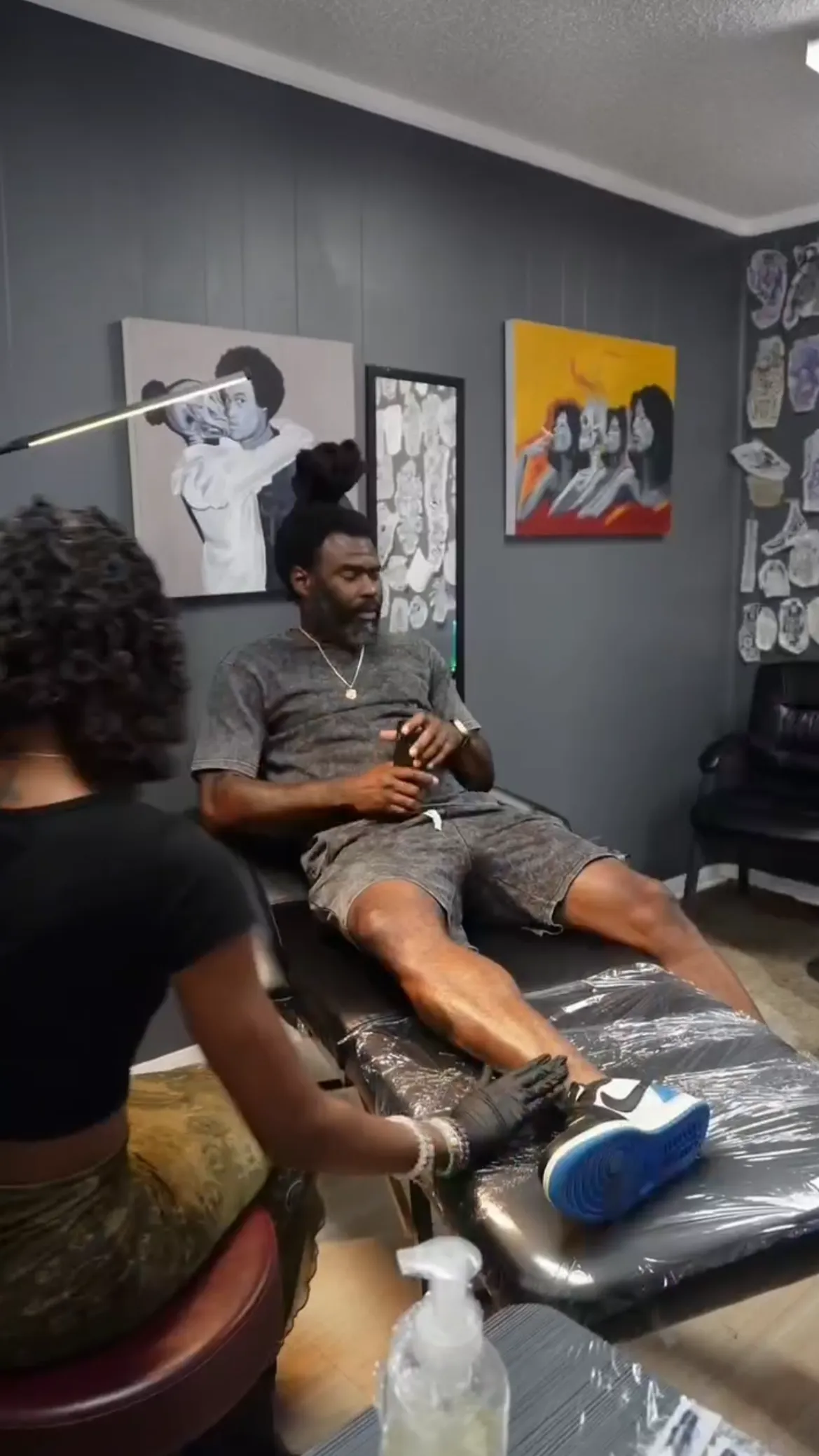 Client relaxing inside Nishay Tattoos’ private Austin tattoo studio