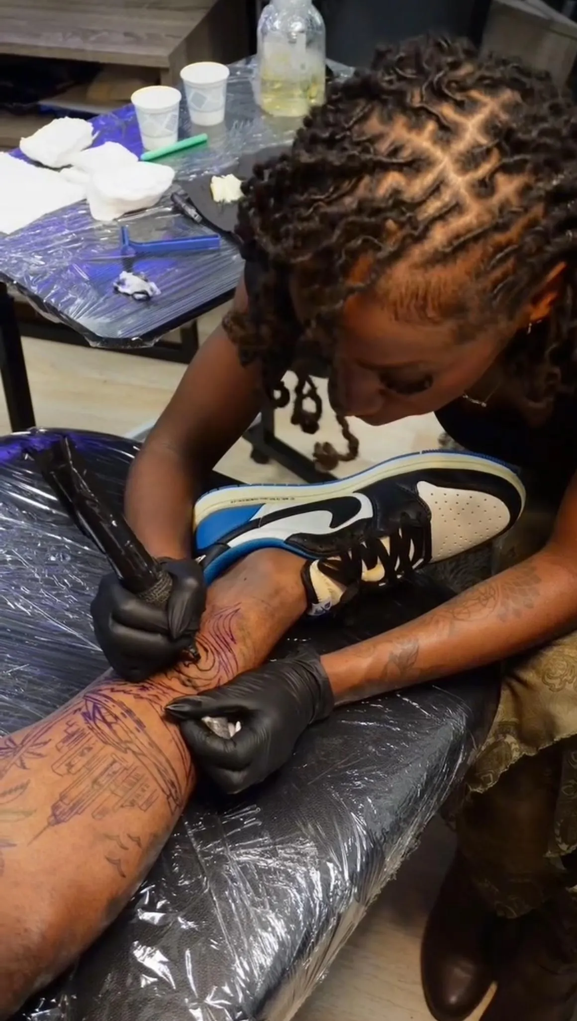 Austin tattoo artist Nishay working on a custom leg tattoo