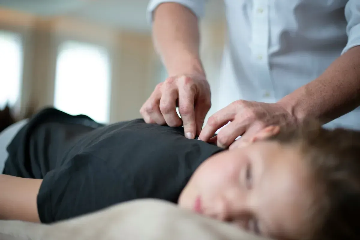 Chiropractor performing spinal adjustment on patient in Kenosha WI