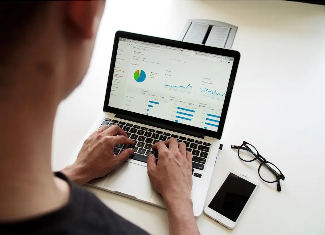 A man managing a Google Ads account on a laptop.