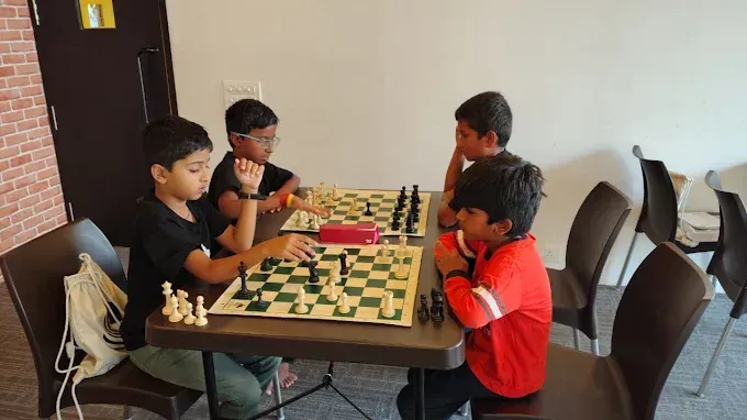 Chess students playing games during a coaching session at CHESS KLUB