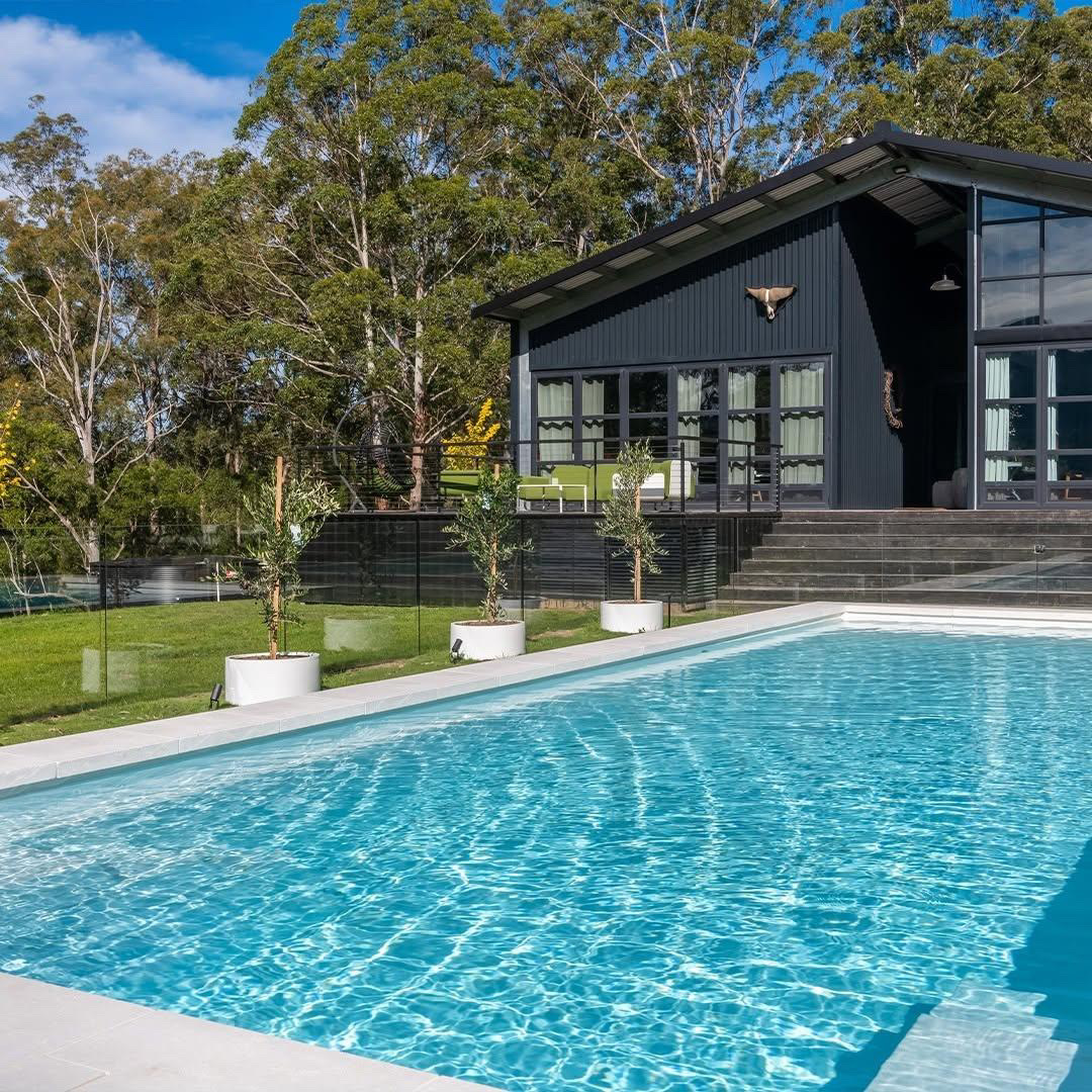 Luxury backyard pool at sunset with warm lighting
