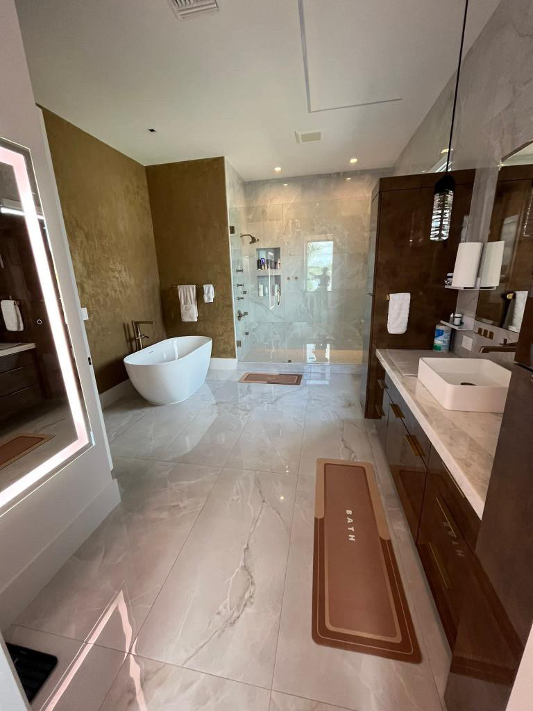 Professional home cleaner tidying a bright modern living room