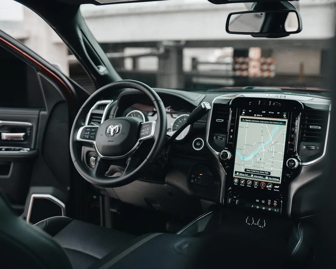 A small toy is sitting on the dashboard of a car