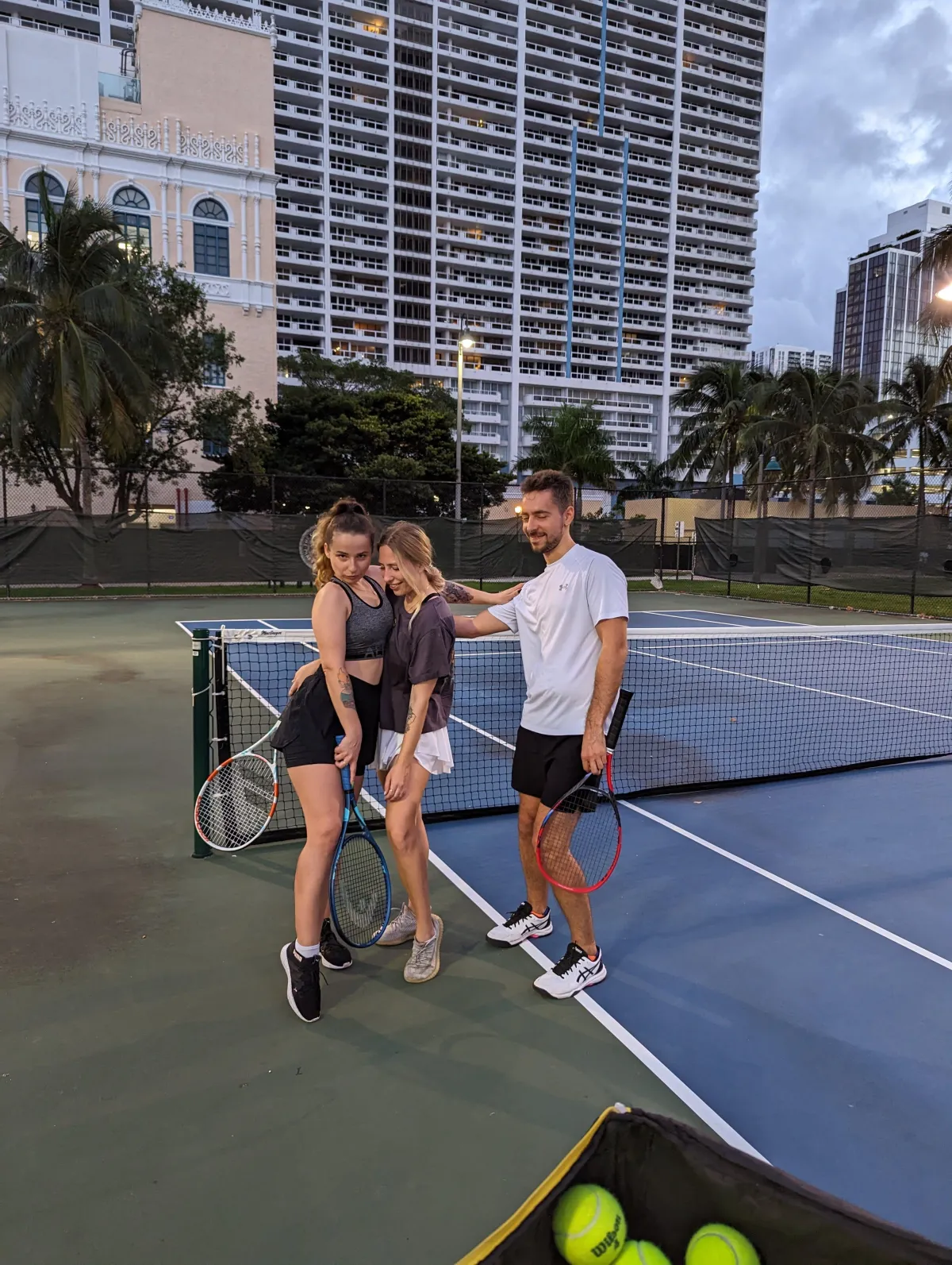 woman in black sports bra holding blue and black kettle