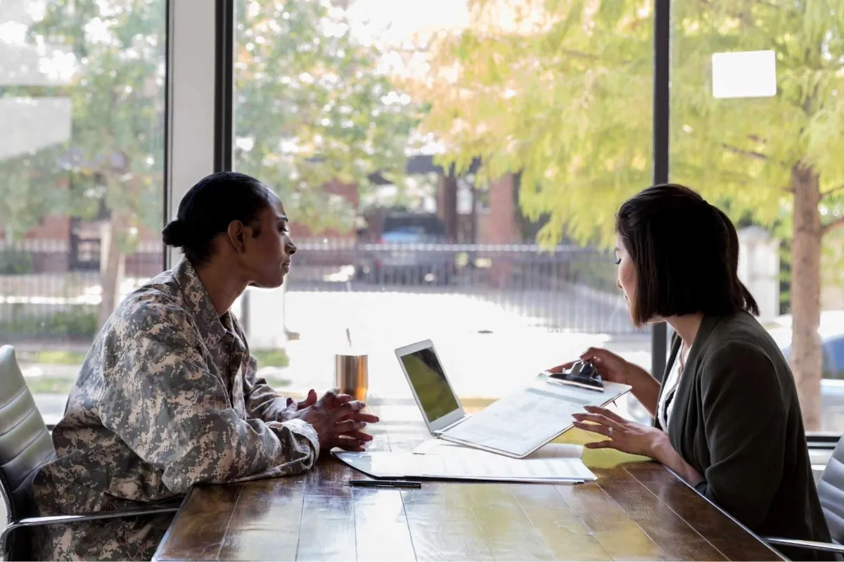female veteran reviewing her finances with a financial advisor, discussing business protection solutions and retirement planning