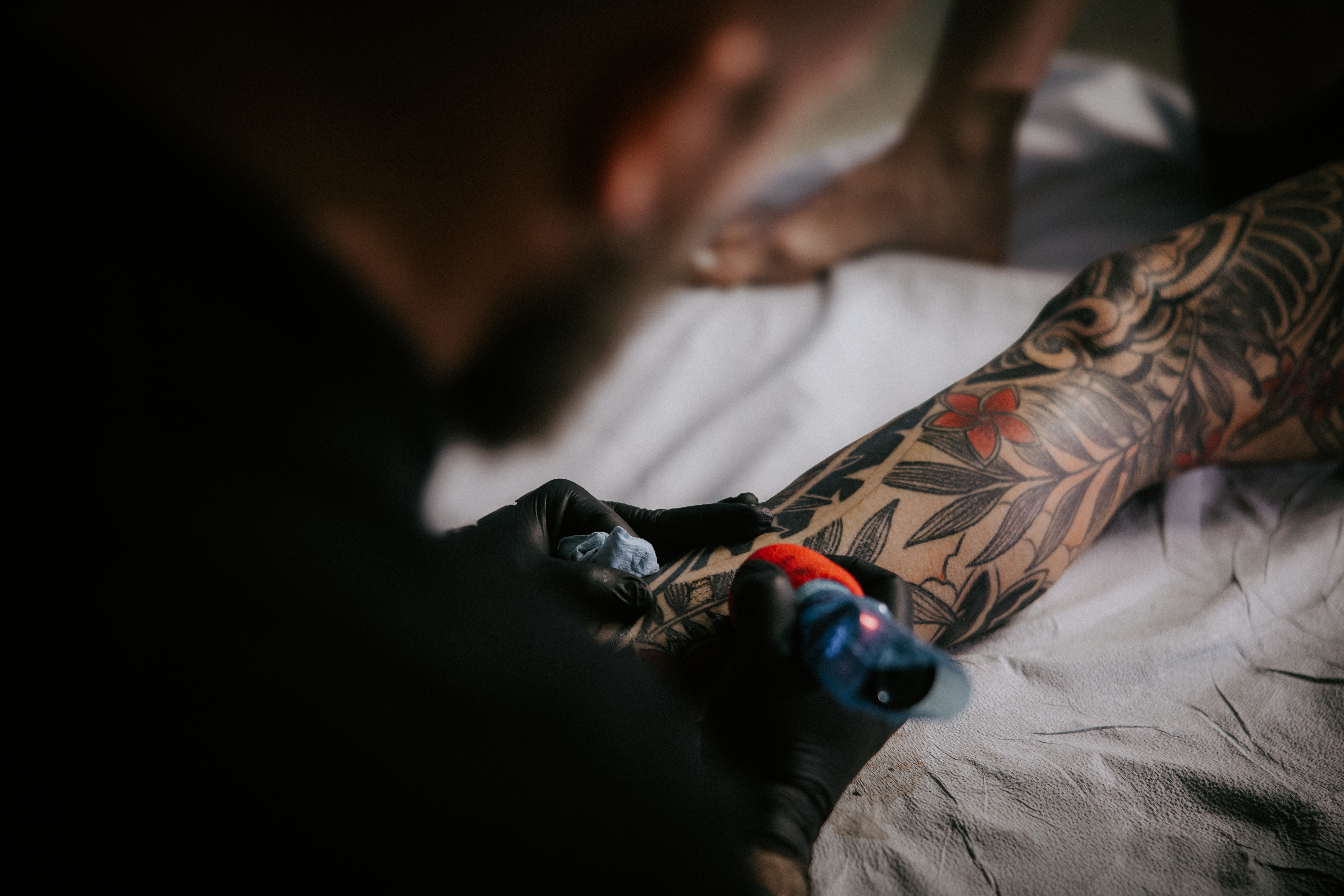 Tattoo artist covering up old tattoo