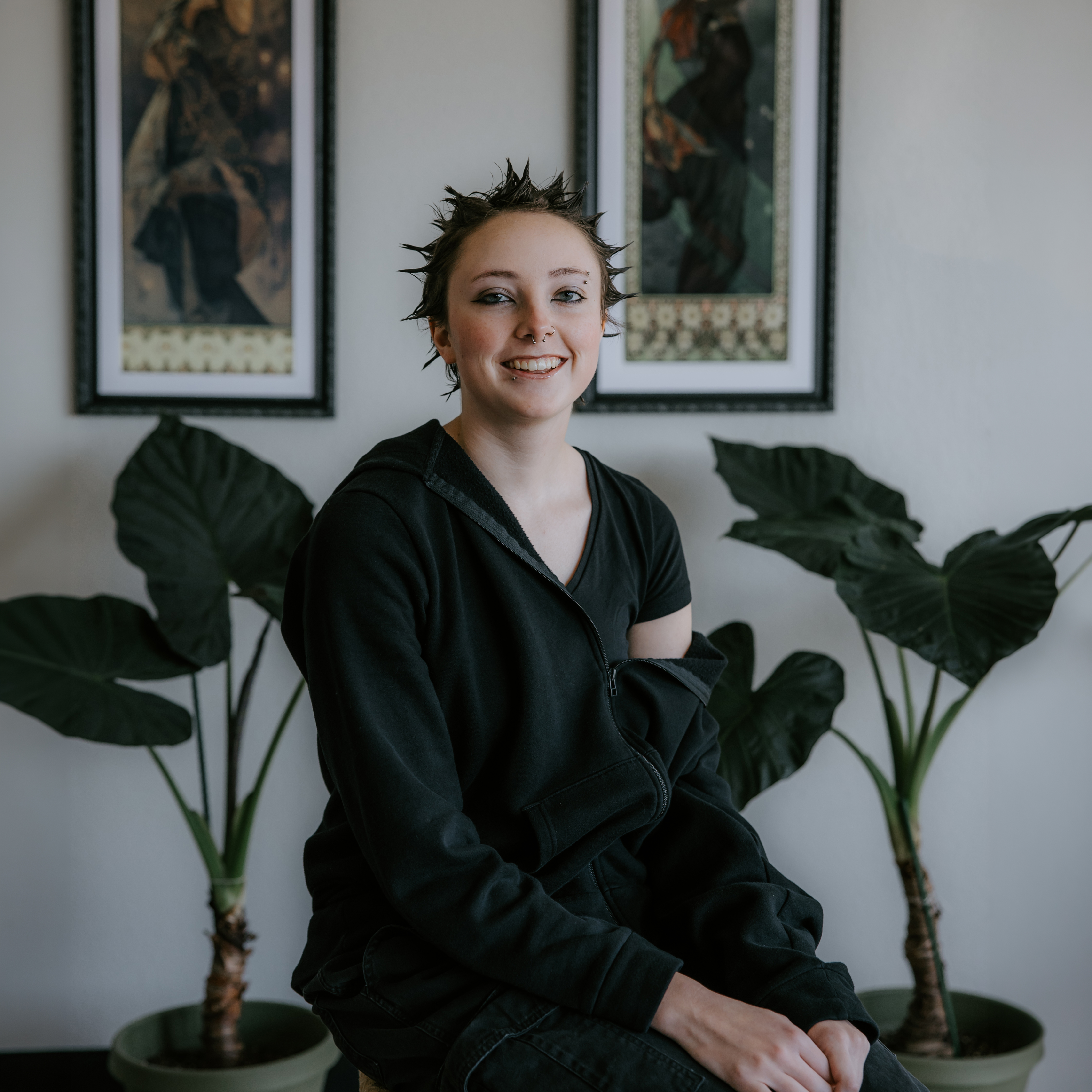 Aiden Pearson Sitting on Stool being the best american traditional artist at red arbor tattoo shop