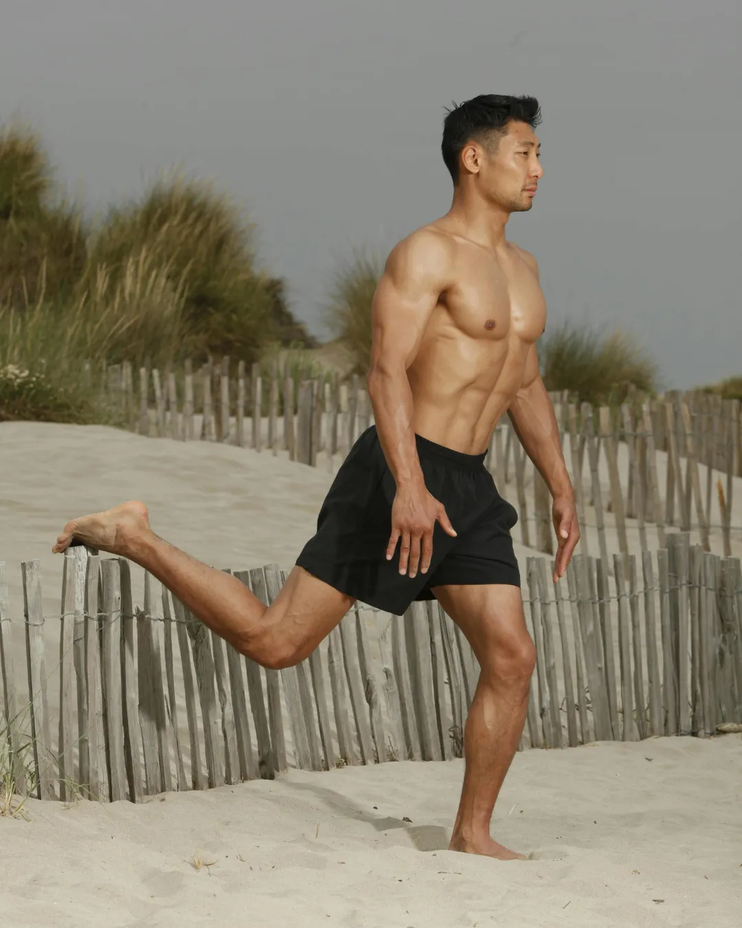 man exercising on beach