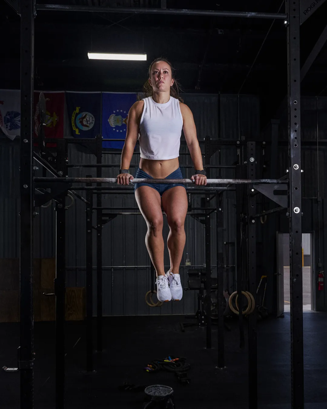 Fit woman doing muscle ups on a bar