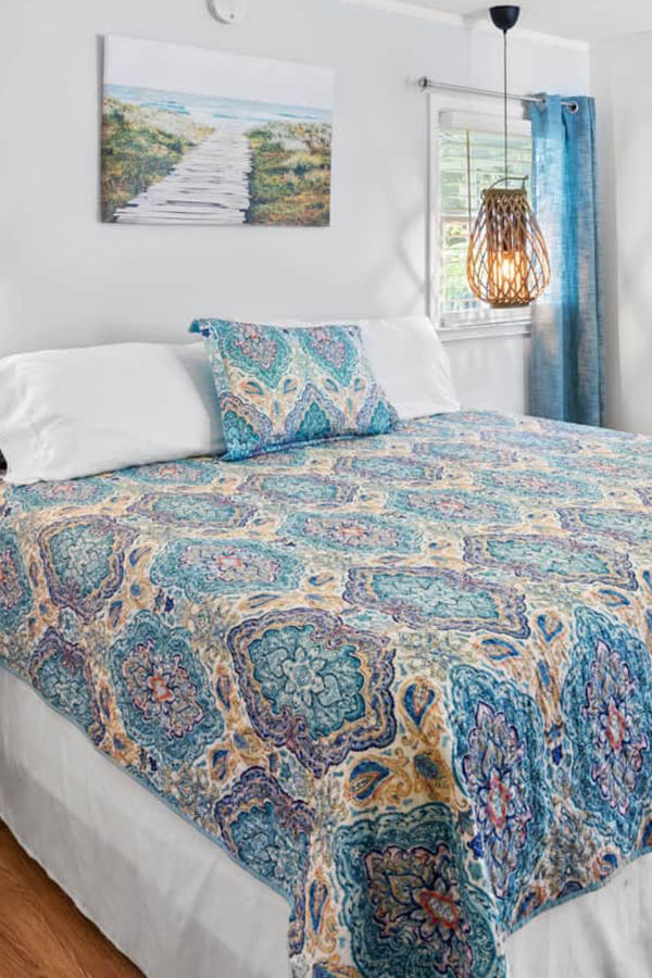 woman setting sheets on bed