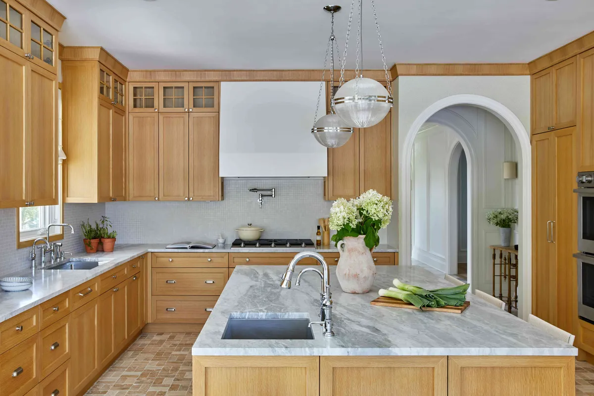 Alexandria Kitchen & Bath Remodel team designing an open-concept kitchen with elegant lighting and island seating