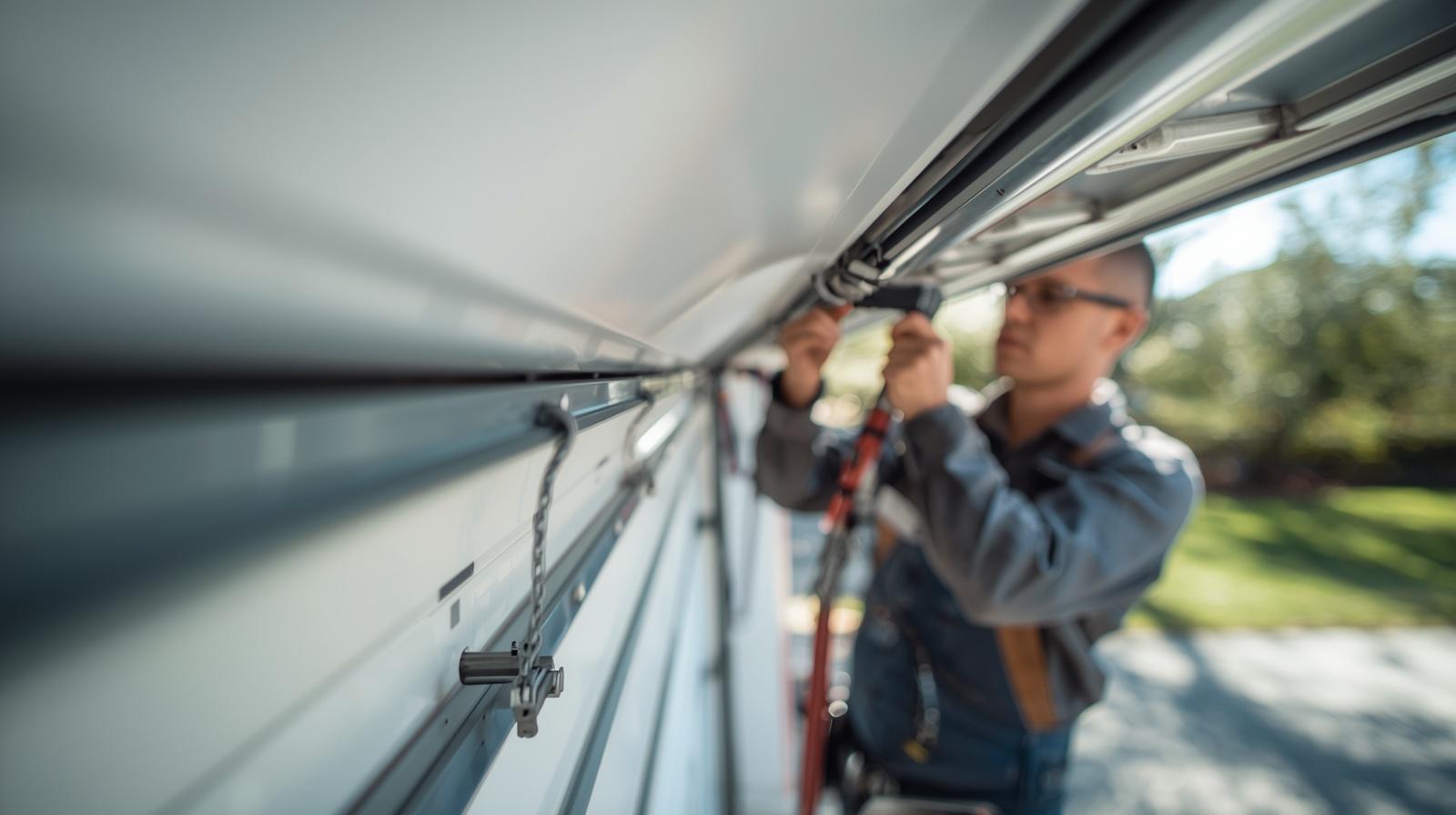 Man repairing garage door.