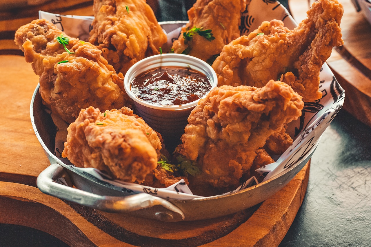Platter of crispy Korean fried chicken with dipping sauces