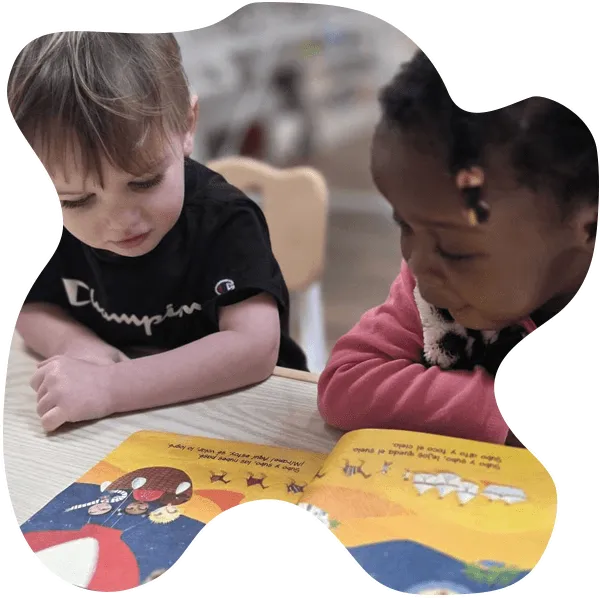 Teacher reading a Spanish story to children at Aventuras Childcare.