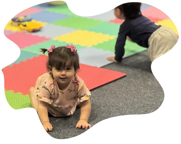 Marisol helping children build with colorful blocks at Aventuras Childcare.