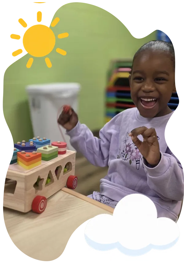 Marisol helping children build with colorful blocks at Aventuras Childcare.