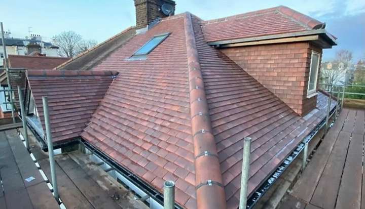 New tiled roof with skylight and ridge tiles completed by Five Star Roofing