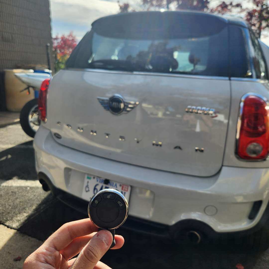 Mobile car key replacement completed with key in hand near vehicle