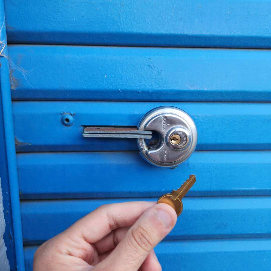 Storage unit lockout assistance with key held beside unit lock