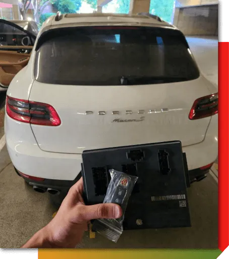 Mobile automotive locksmith holding a programmed car key and remote beside a vehicle