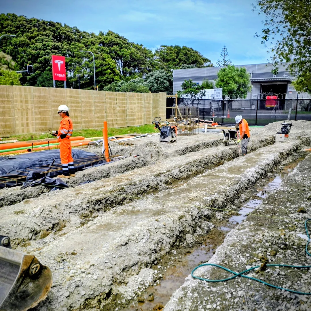 Civil construction crew completing drainage and concrete works in Auckland