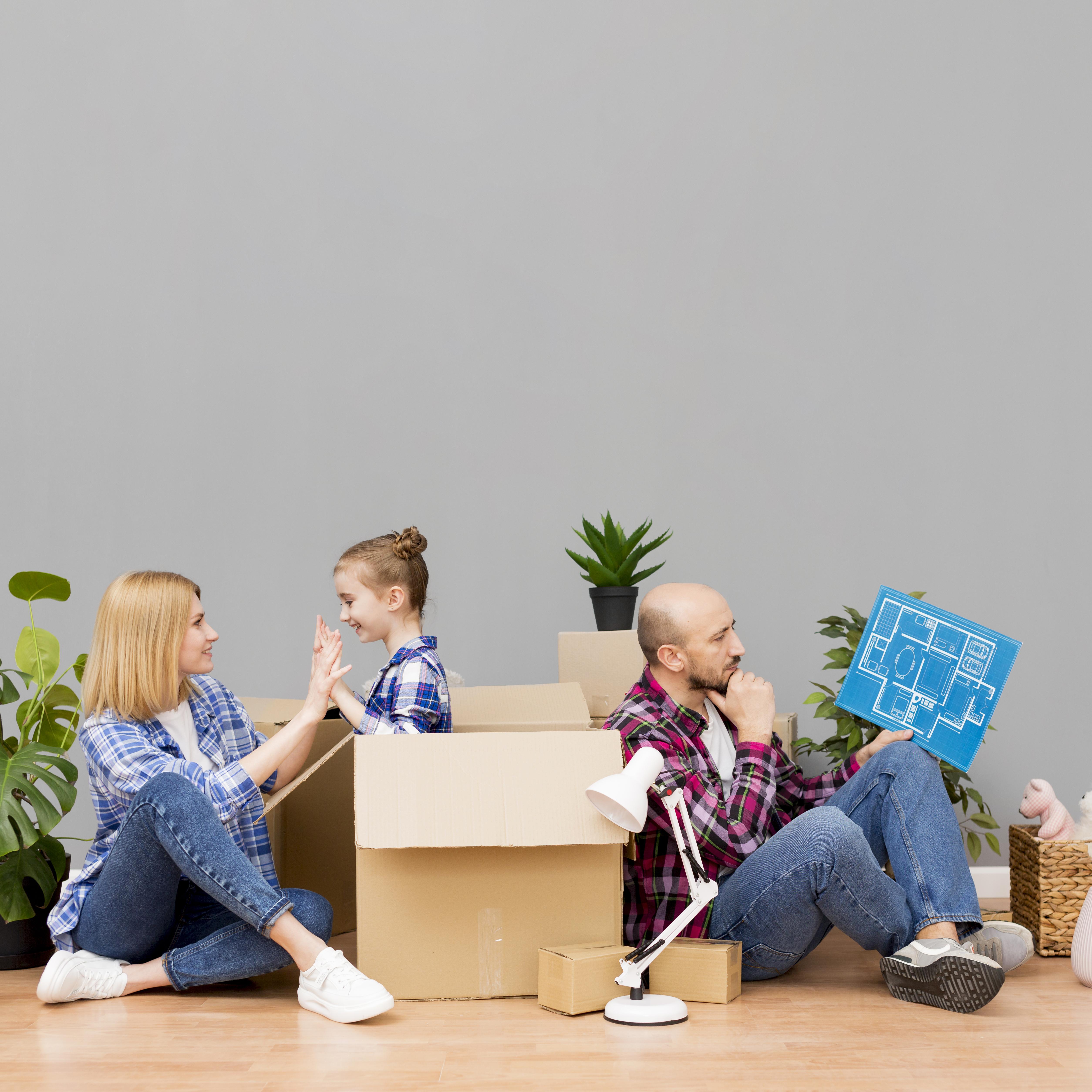 A happy Dallas family in their living room with moving boxes, representing the peace of mind a 2026 temporary occupancy agreement provides.