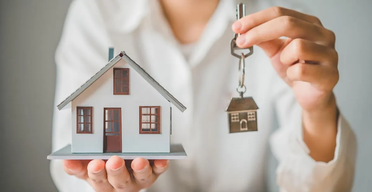 person covered in white blanket while laying on bed