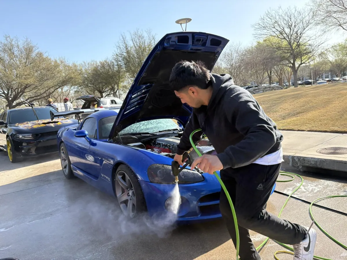a white porsche car parked in a garage