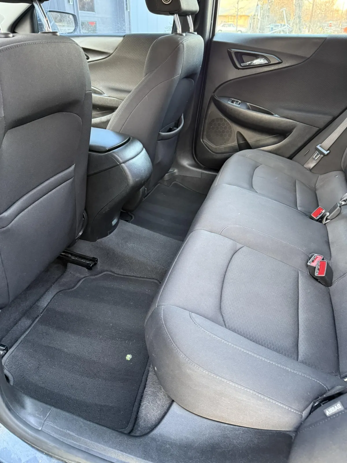 a couple of cars parked next to each other in front of a building