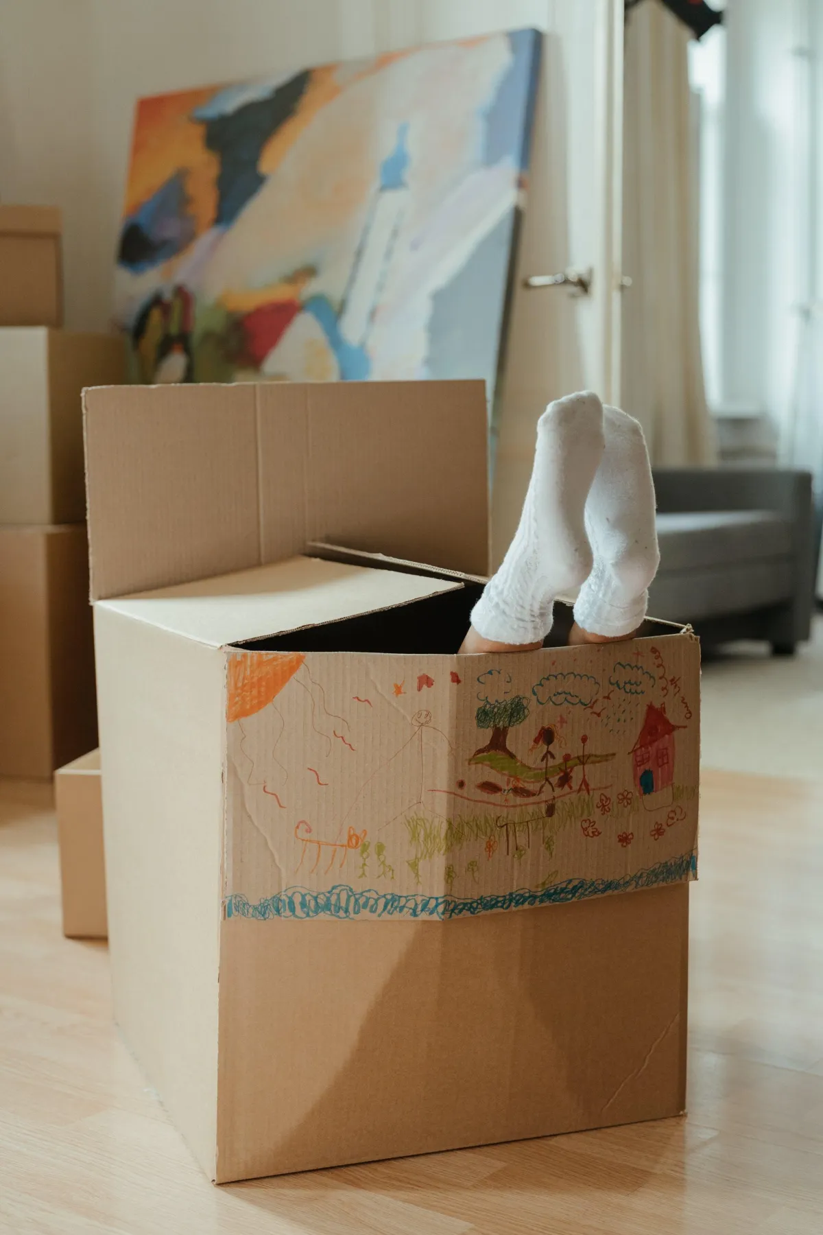 Feet sticking out of a moving box during cleaning