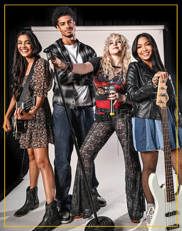 Group of teens playing guitar, bass, and singing during a Rockstars of Tomorrow band lesson program.