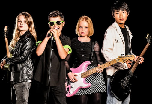 Group of young musicians performing with guitars and a microphone, showcasing youth band music lessons and live performance programs at Rockstars of Tomorrow.