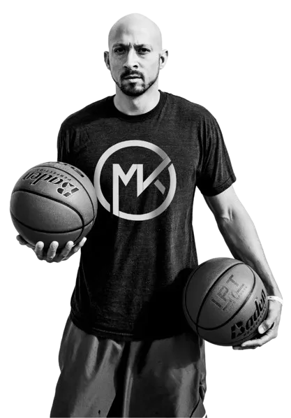 Wide-angle view of the new Medora basketball training facility, featuring polished hardwood courts, modern lighting, and IPT branding banners. The space is empty, emphasizing the premium, professional environment.