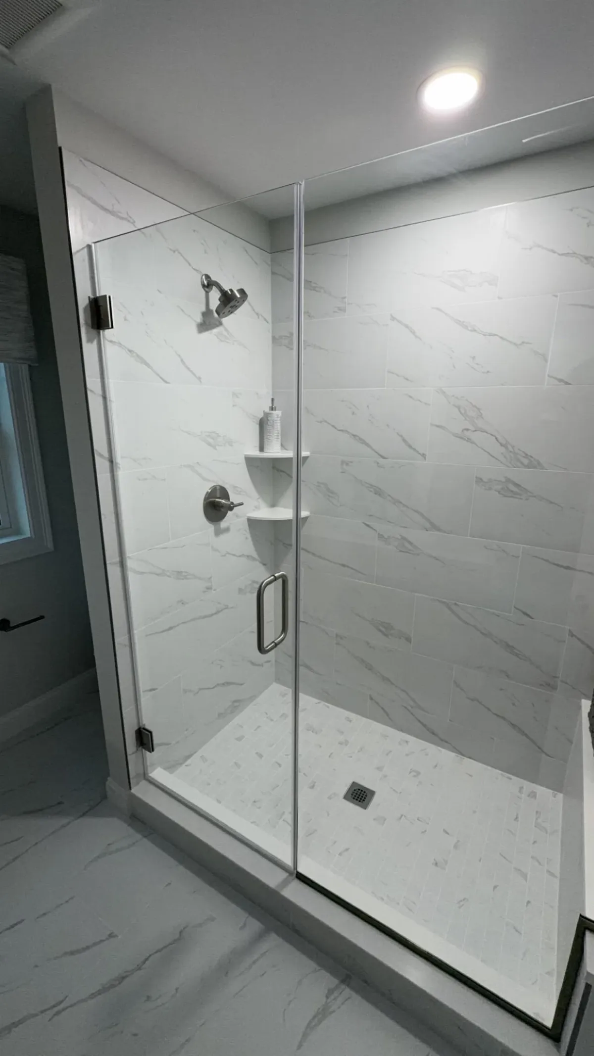 Remodeled bathroom with navy vanity, quartz counter, and undermount sink plumbed by MJC Plumbing
