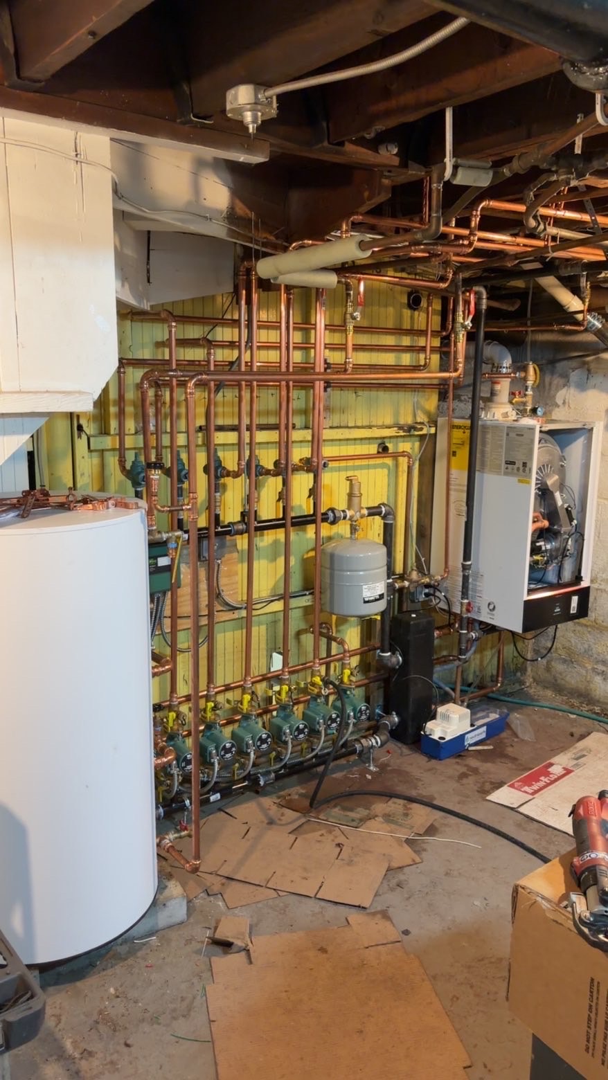 Copper supply piping and near-boiler connections in a residential mechanical room installed by MJC Plumbing