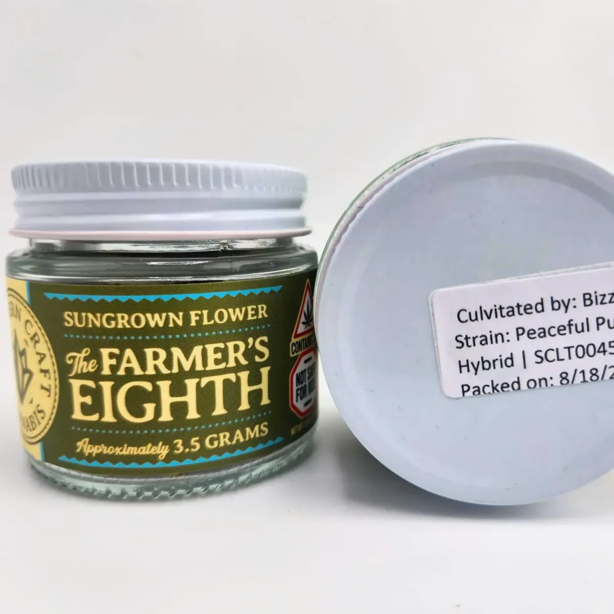 Jar of The Farmer’s Eighth cannabis flower, sungrown hybrid strain “Peaceful Puppy,” approximately 3.5 grams with branded label and lid details