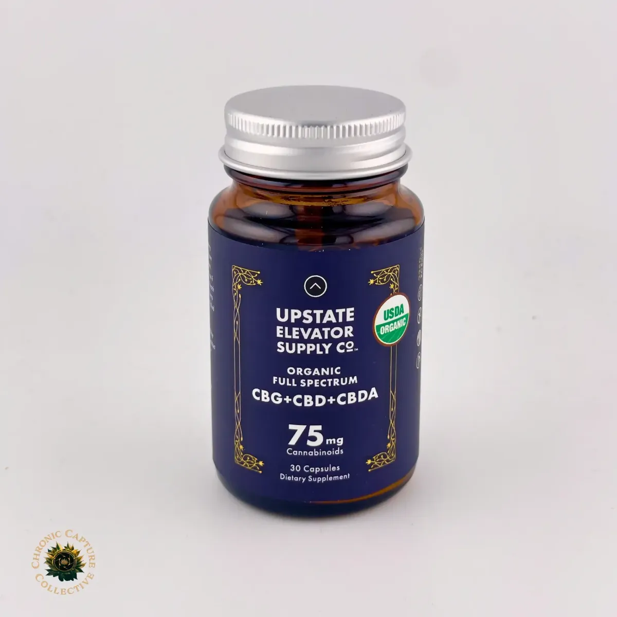 Upstate Elevator Supply Co. Organic Full Spectrum Capsules with CBG, CBD, and CBDA, 75mg cannabinoids per serving, 30-count dietary supplement in dark blue bottle with silver cap.