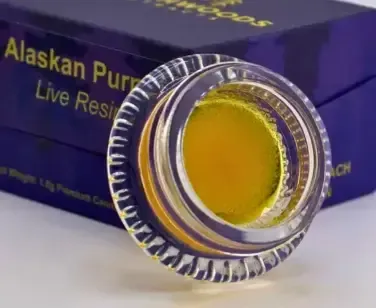 Cannabis concentrate live resin in glass container with packaging