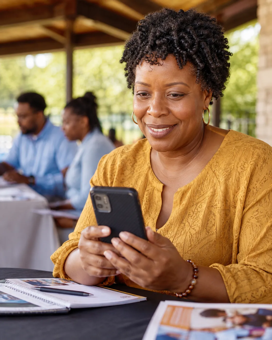 A person using a smartphone in a community context, demonstrating mobile accessibility.